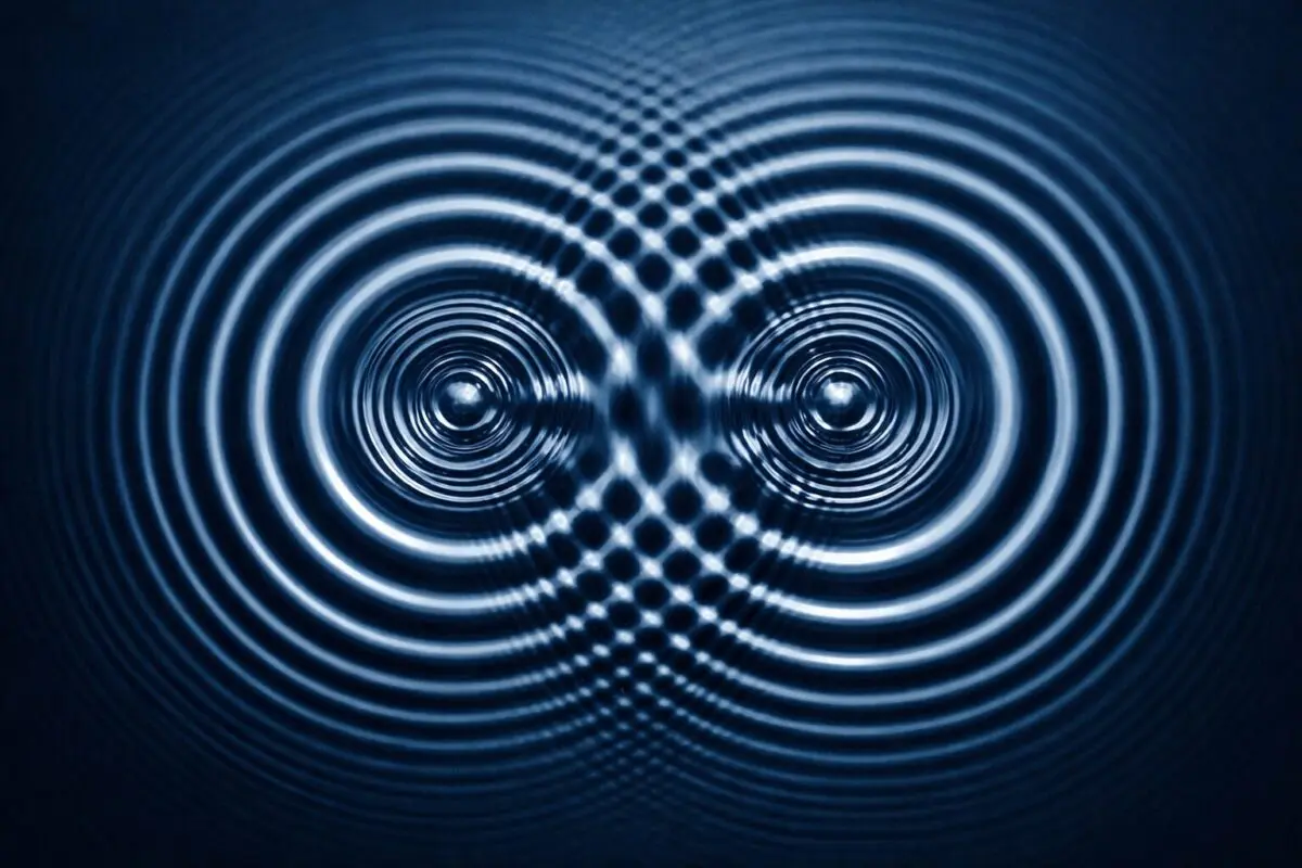 Two water ripples coliding eachother